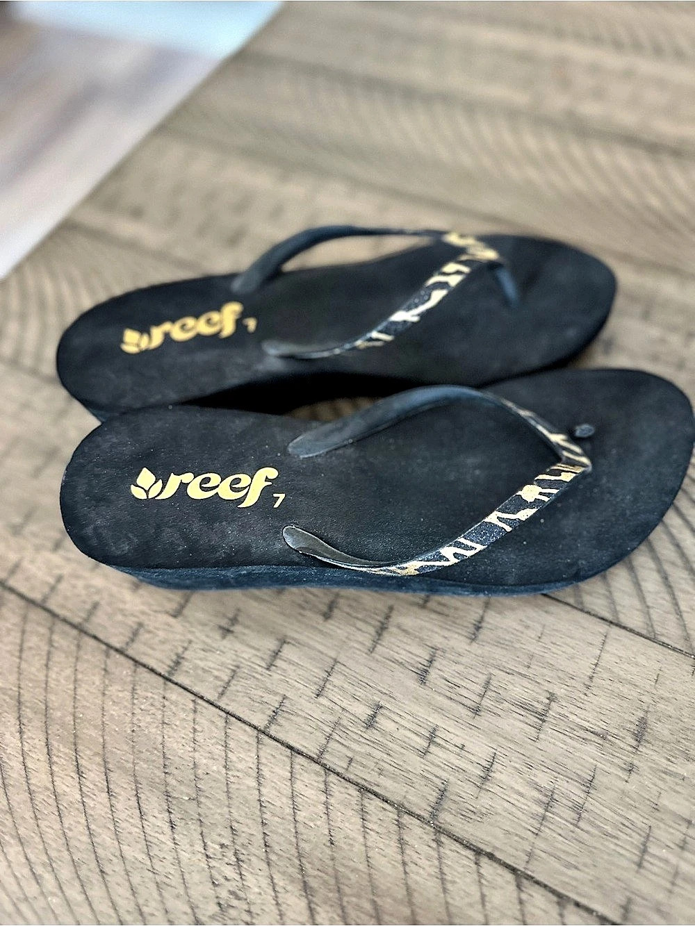 Used and well worn Reef Bliss Nights Black Flip-Flop Sandals, Size 7